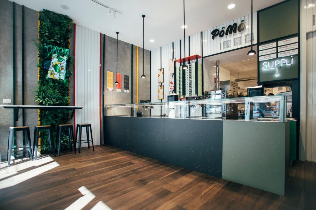 Pizzeria Pomò sala con parquet, giardino verticale, bancone