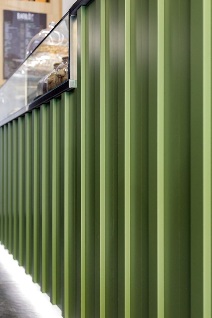 detail of green industrial style cocktail bar counter