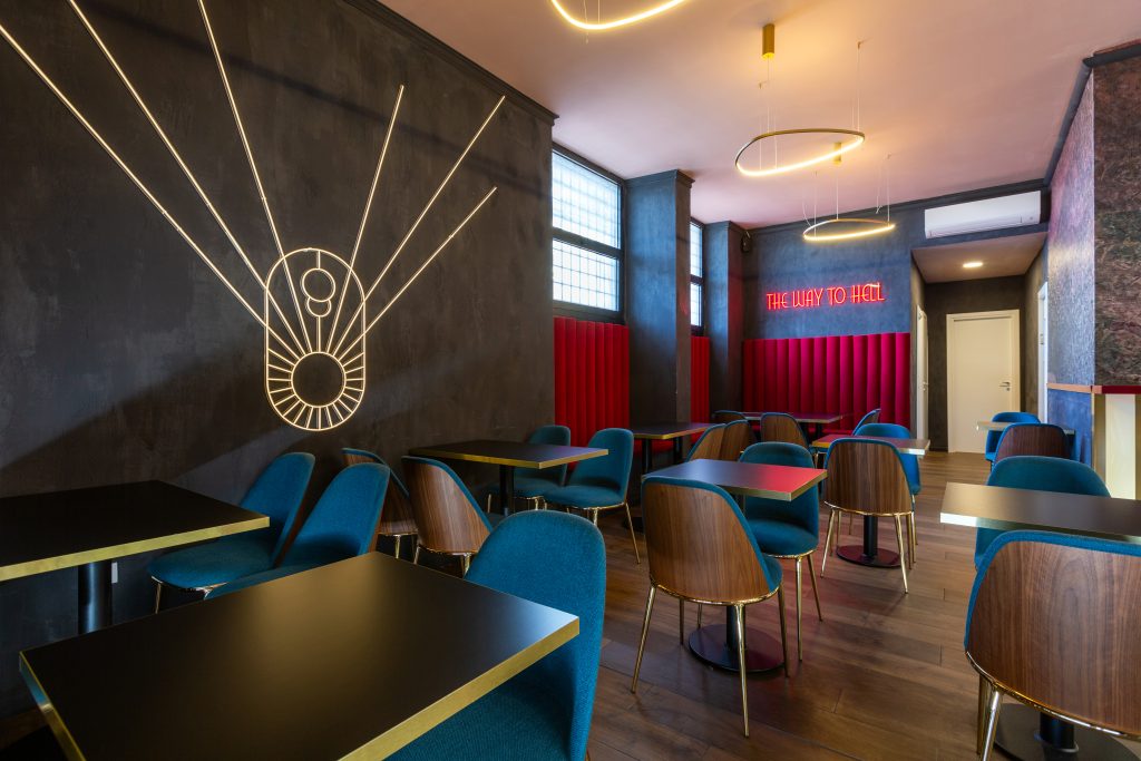 Lux cocktail bar room with tables and chairs
