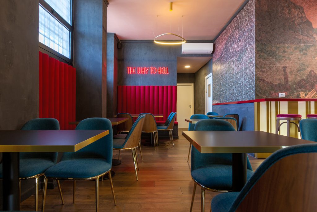 Lux cocktail bar room with small tables, parquet, neon writing
